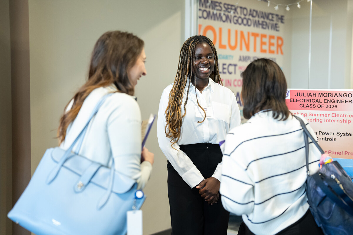 Student talks with employers at a career fair