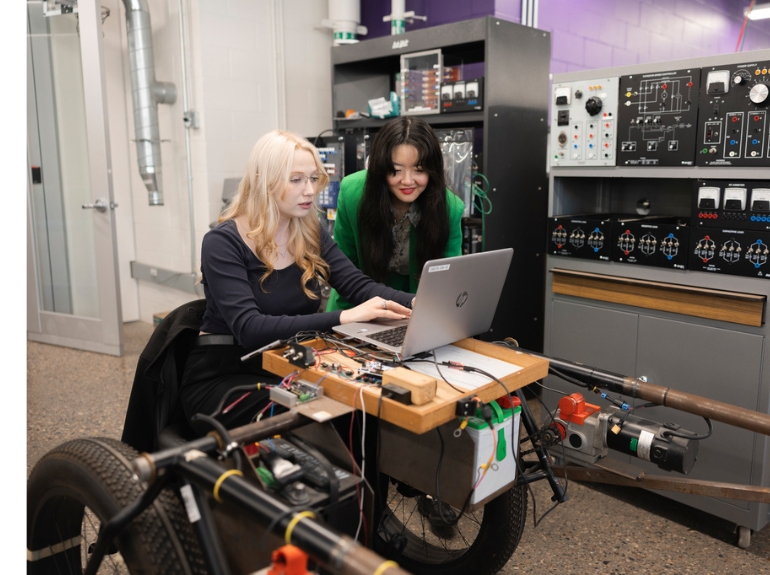 a student works on a research project with a faculty member
