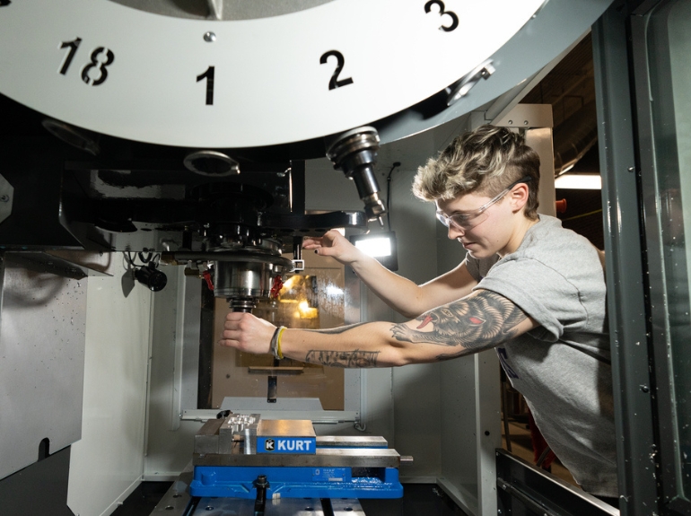 A student uses manufacturing machinery