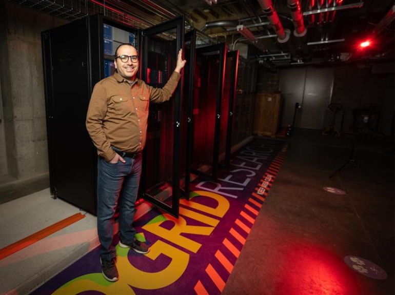 Mahmoud Kabalan stands in the center for microgrid research