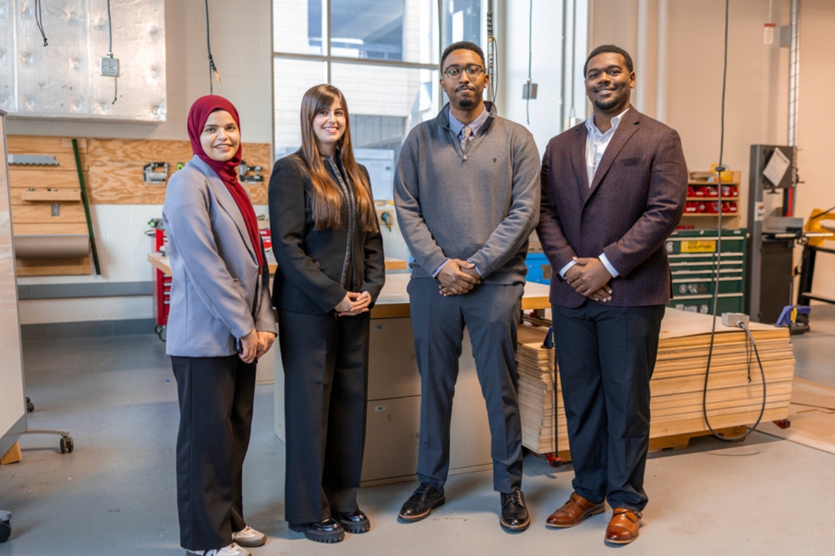 a diverse senior design clinic team poses in the high bay lab