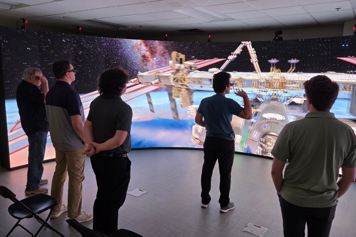 a student demonstrates an idea in the 3-d visualization lab