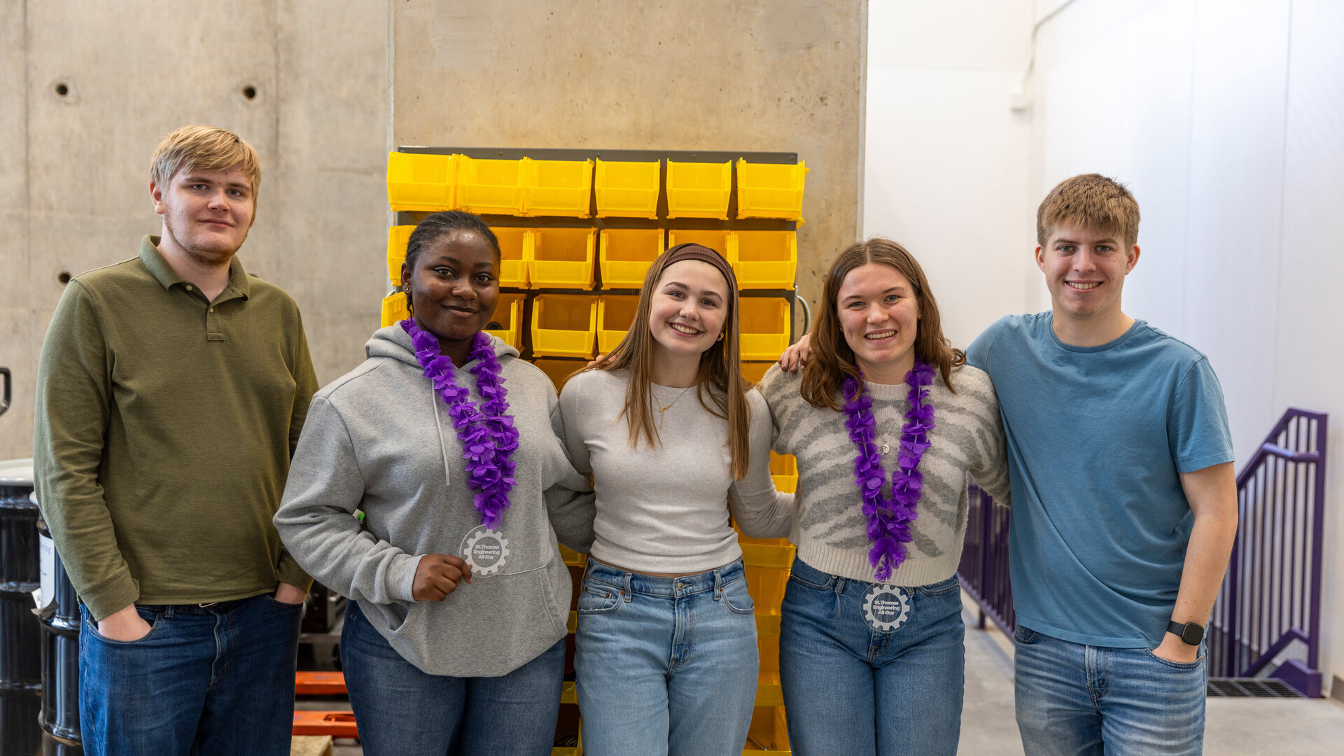 Engineering students participate in Engineering Week activities and wear medals they won.