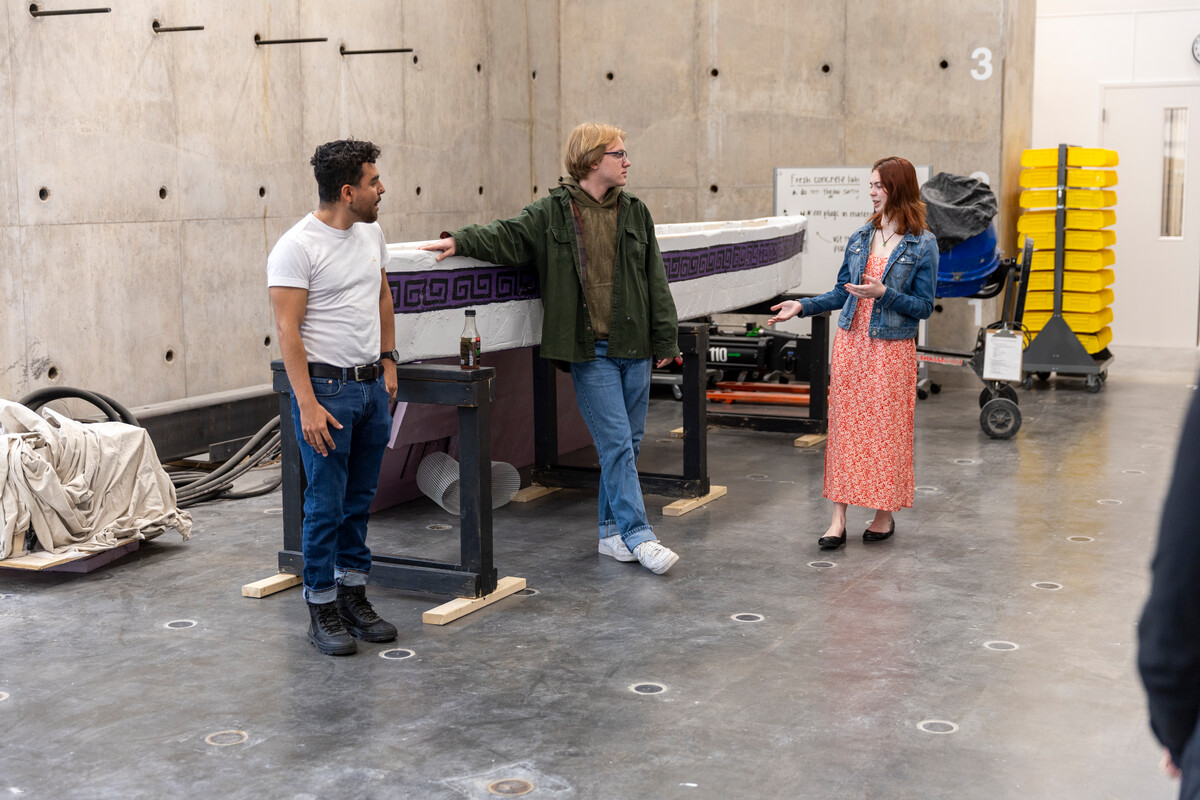 Students present their concrete canoe in the Iversen Structural High Bay