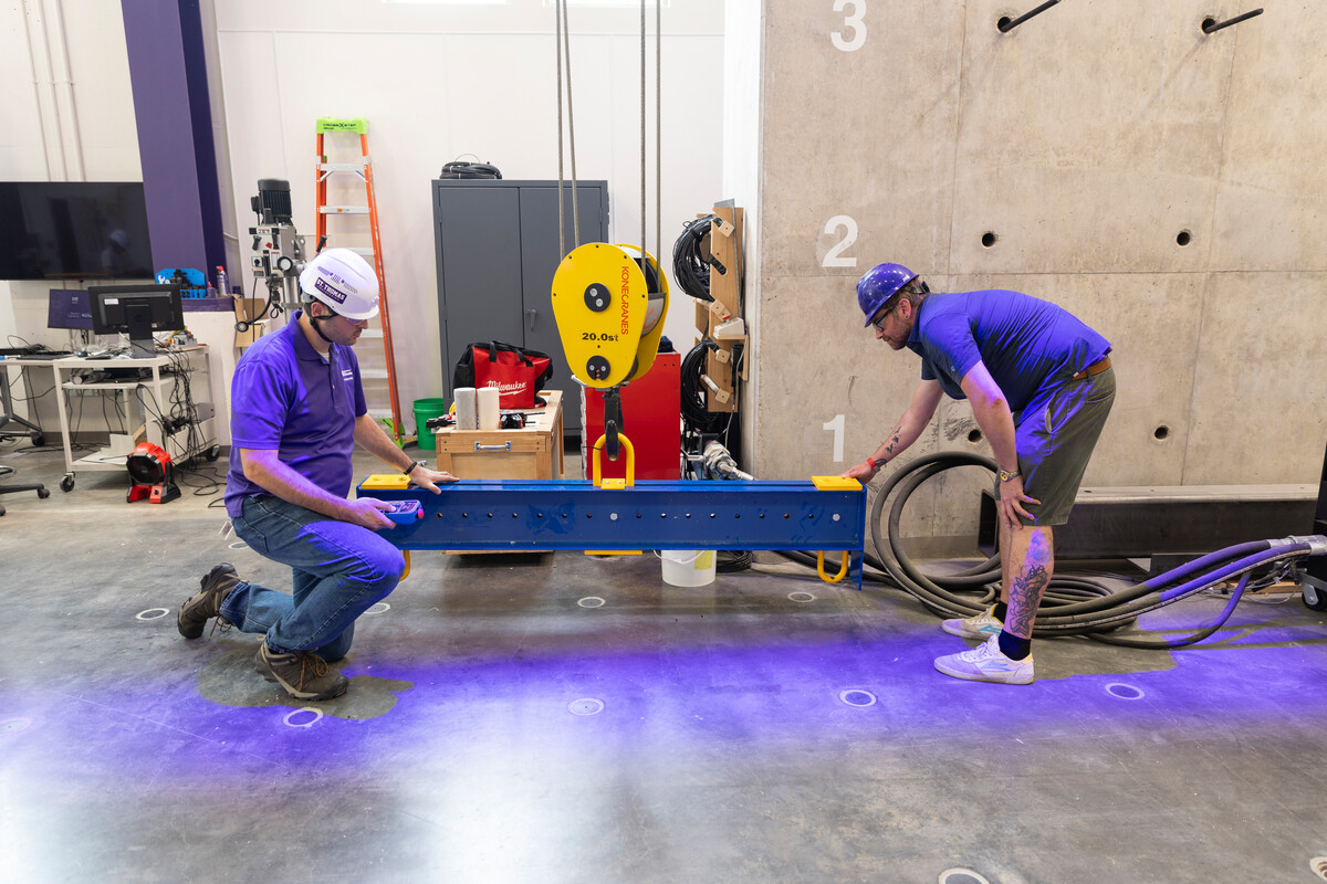 Student and professor use the construction equipment.