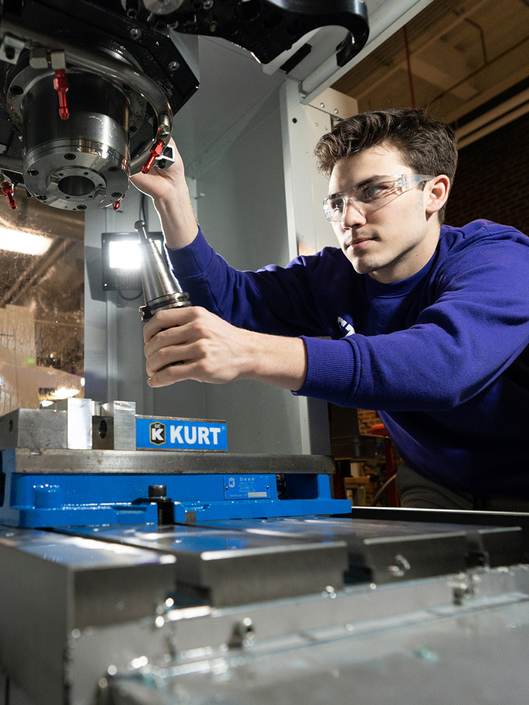 St. Thomas student manipulates CNC machine controls