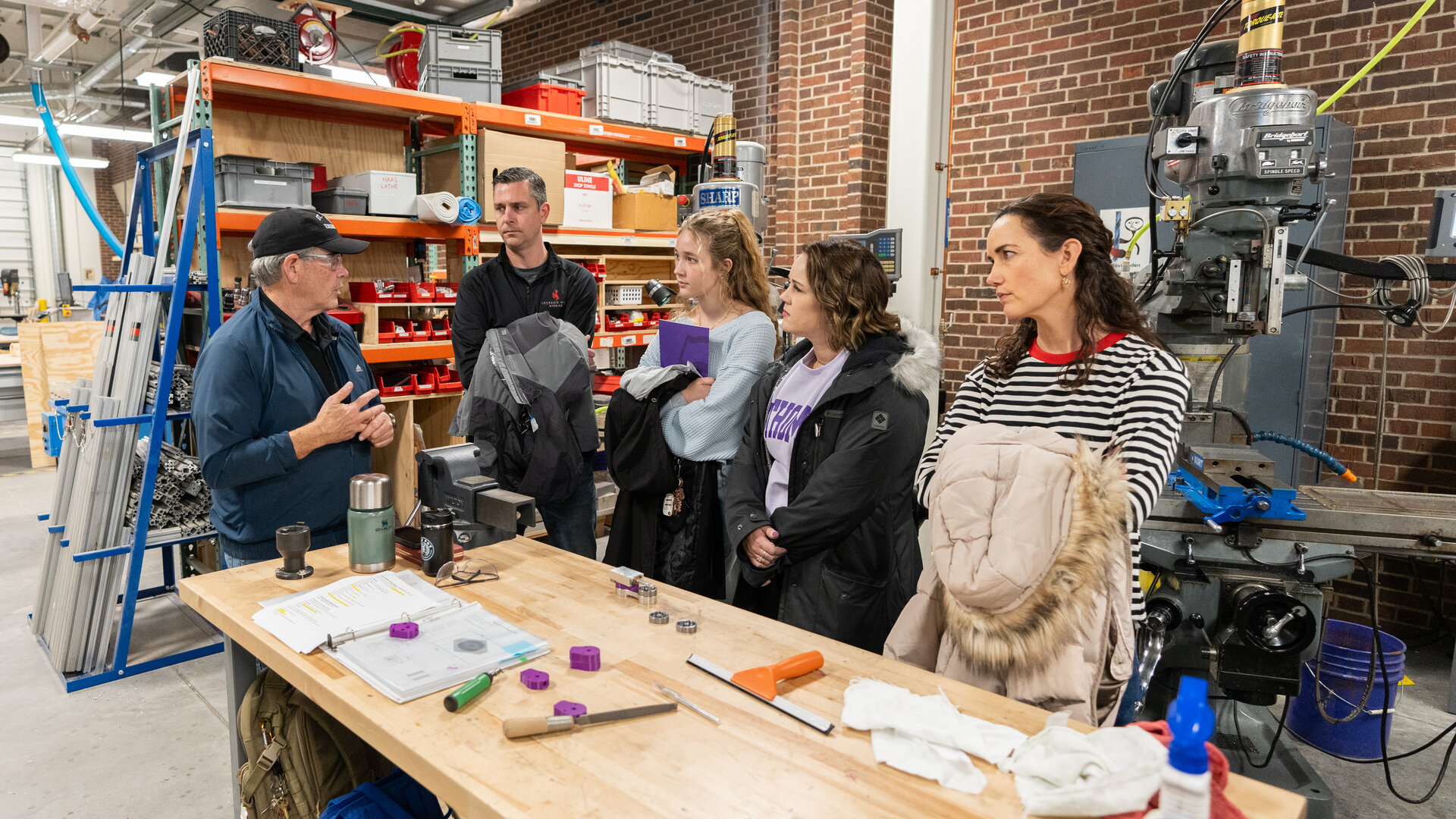 Students meet for a tour in a St Thomas engineering facility.