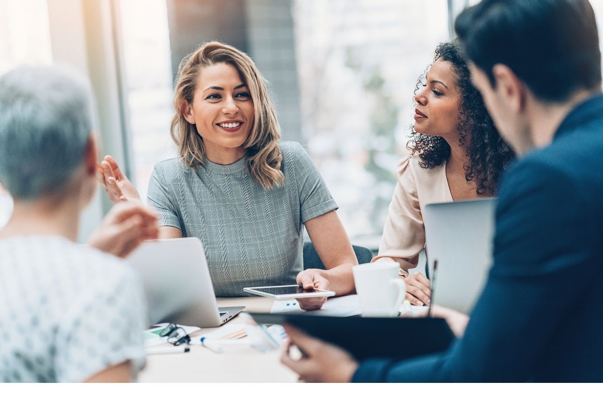 a group of professional men and women having a business meeting