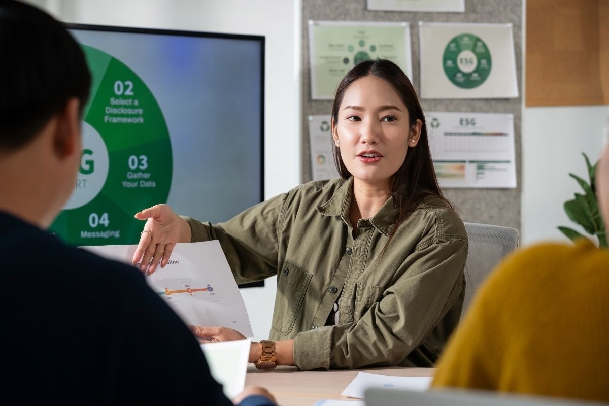 a woman giving a presentation on sustainability 