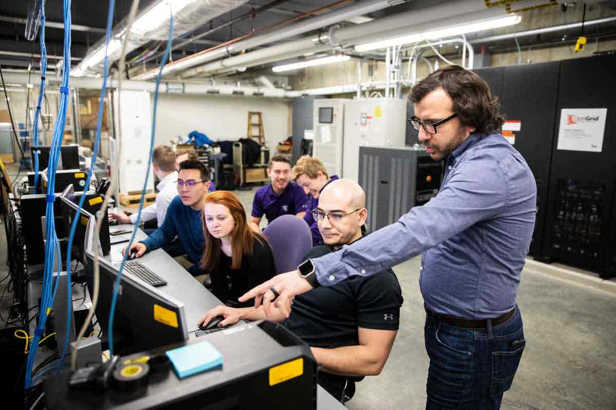 Engineering professor works with students.