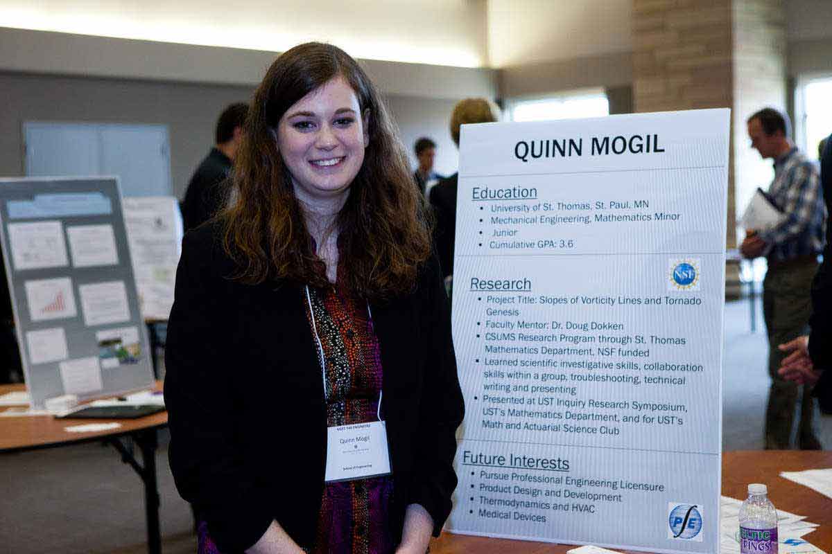 Student waits to present her project at a career fair