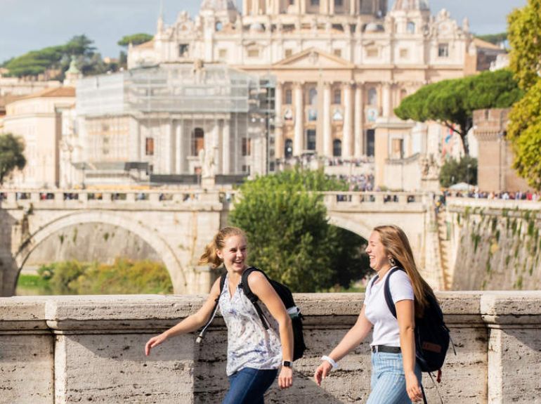 students laughing as they stroll in Rome