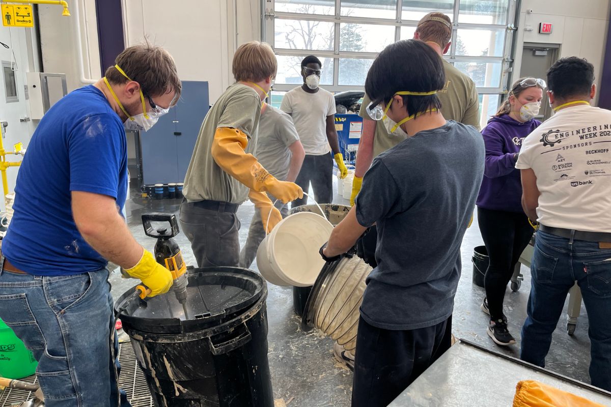 Civil engineering students work on concrete canoe project.