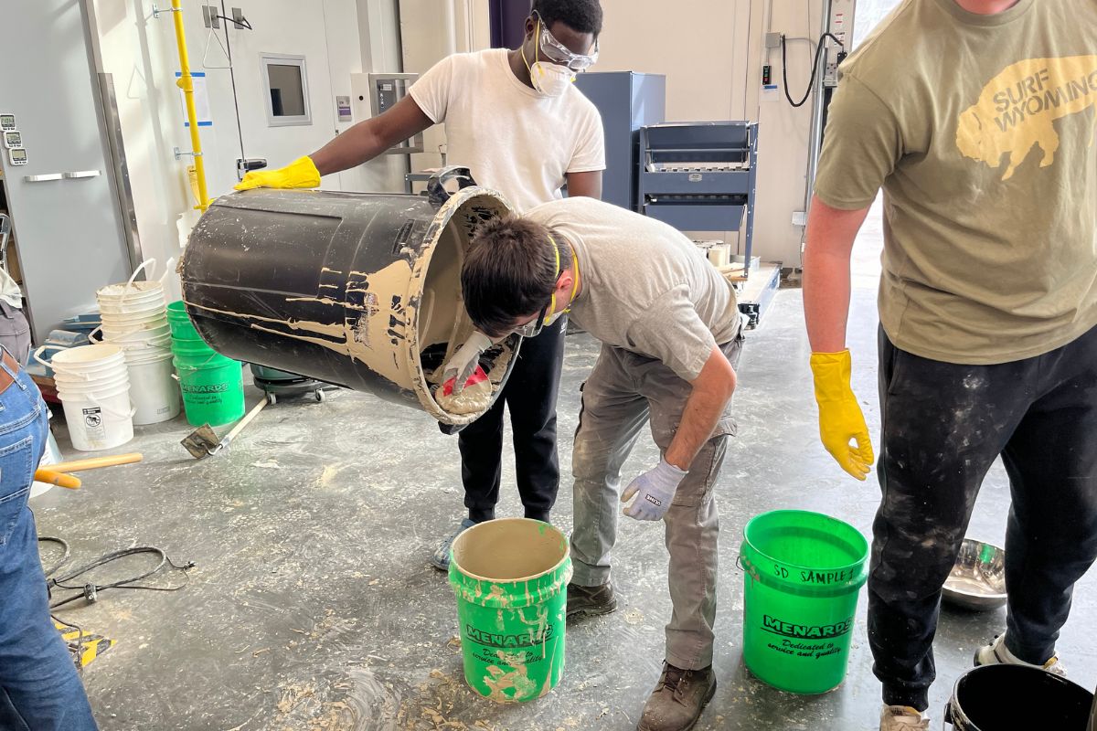 Civil engineering students work on concrete canoe project.