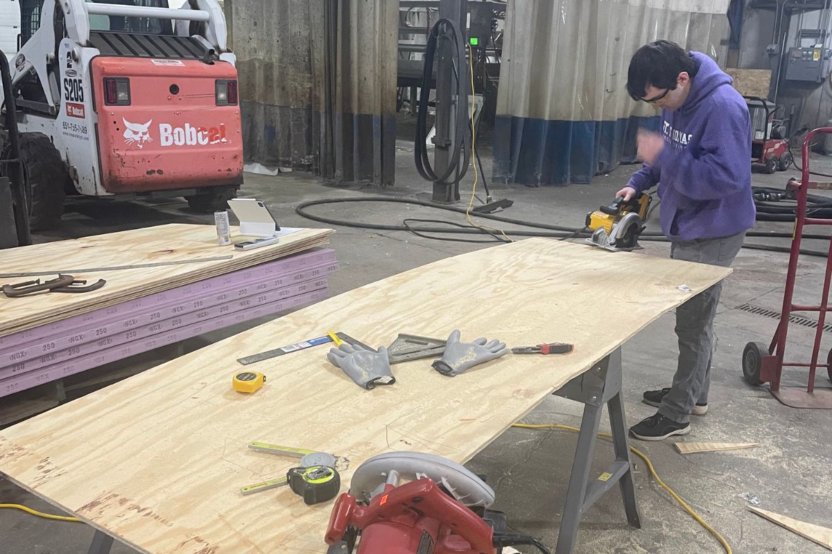 Civil engineering students work on concrete canoe project.