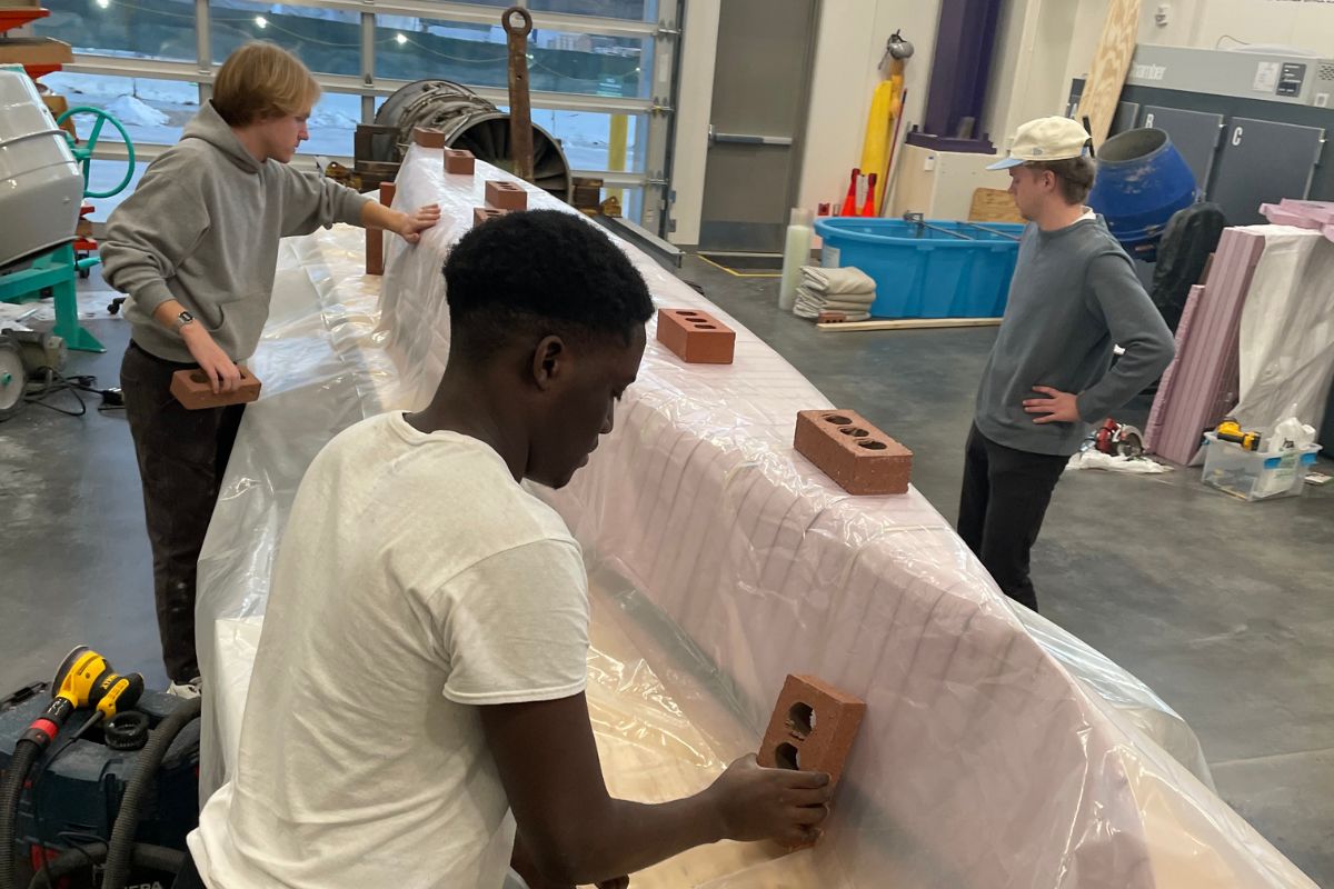 Civil engineering students work on concrete canoe project.