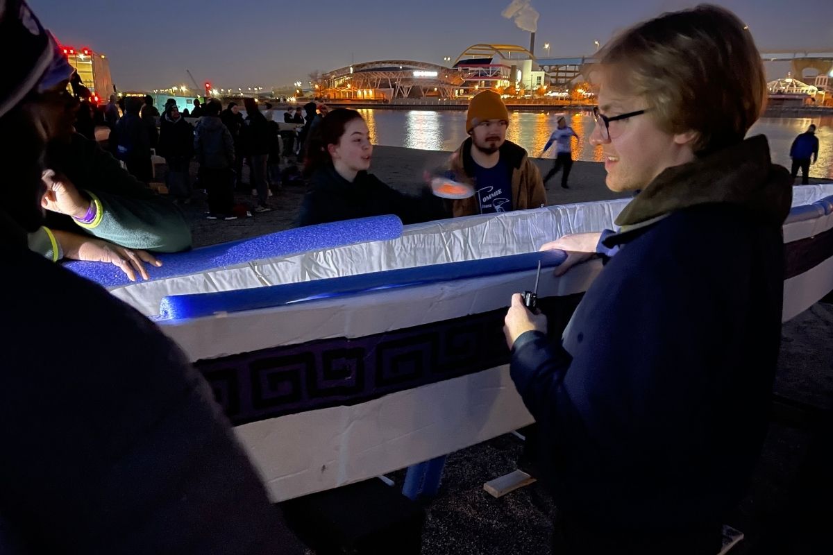 Before sunrise, St. Thomas civil engineering students make final prep to concrete canoe before competition