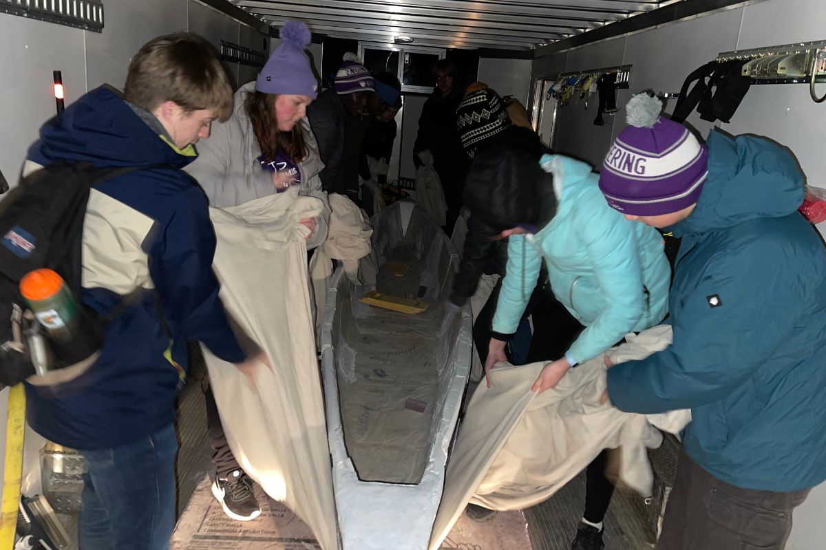 St. Thomas civil engineering students hoist their concrete canoe out of the trailer.