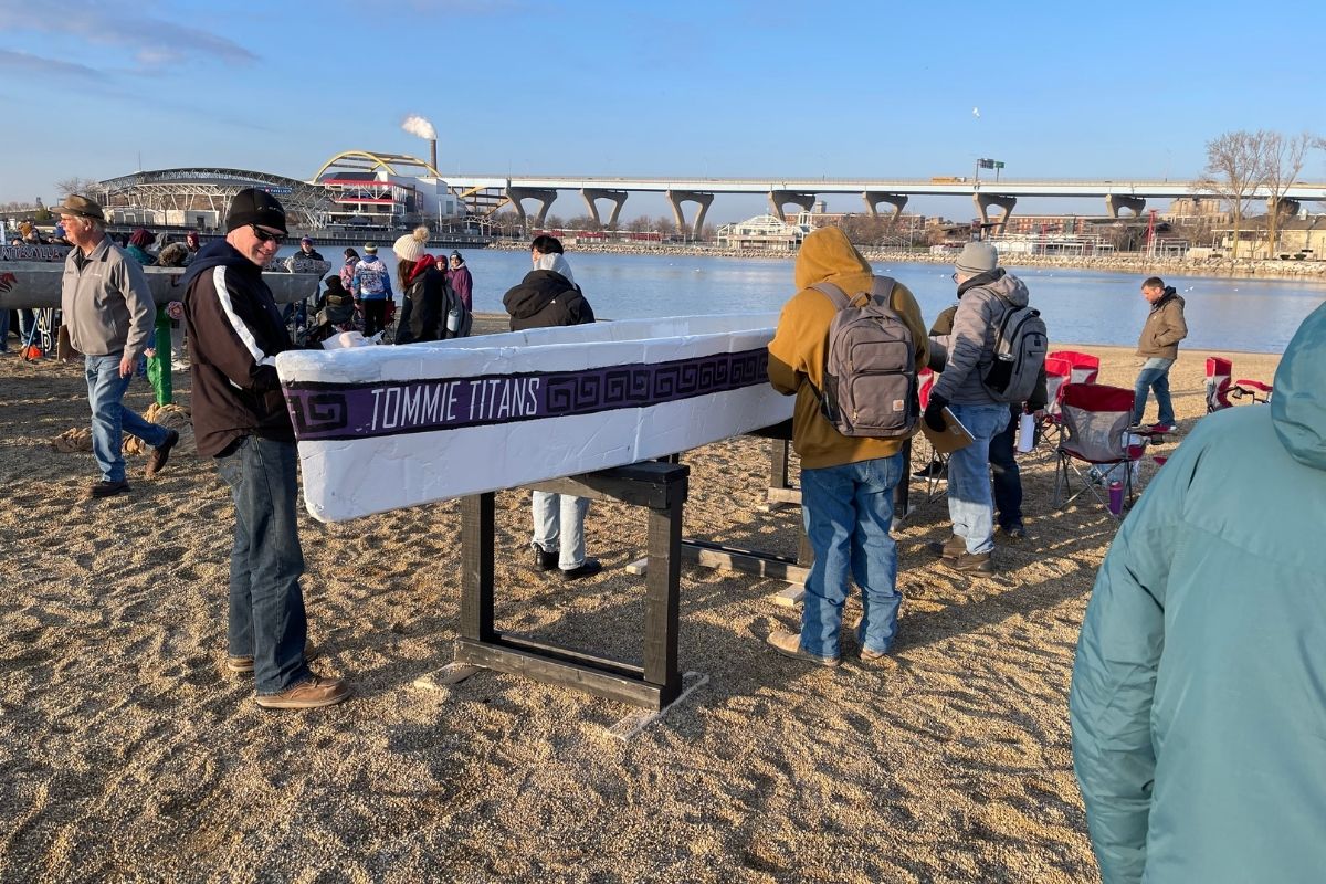 St. Thomas Tommie Titans concrete canoe propped in the sand.