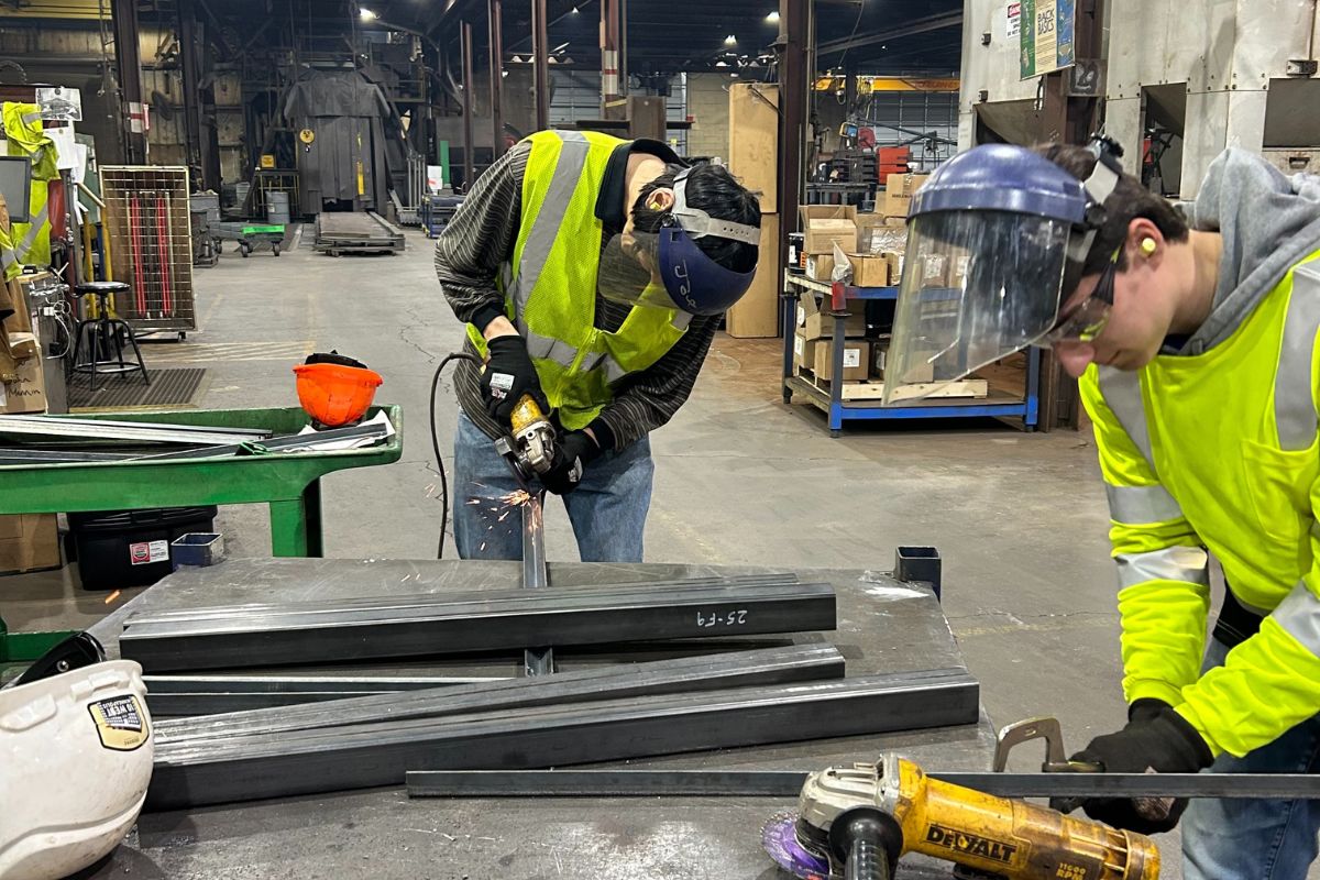 Civil engineering students work on steel bridge project.