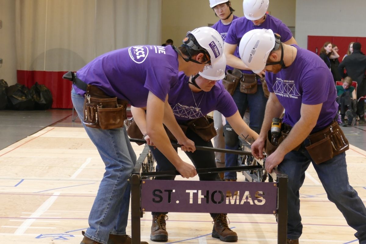 Civil engineering students work on steel bridge project.