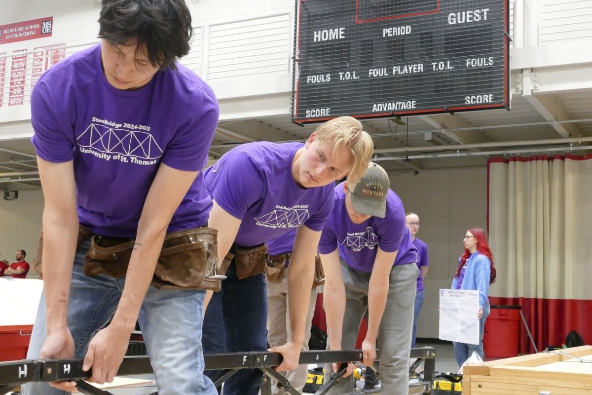 Civil engineering students work on steel bridge project.