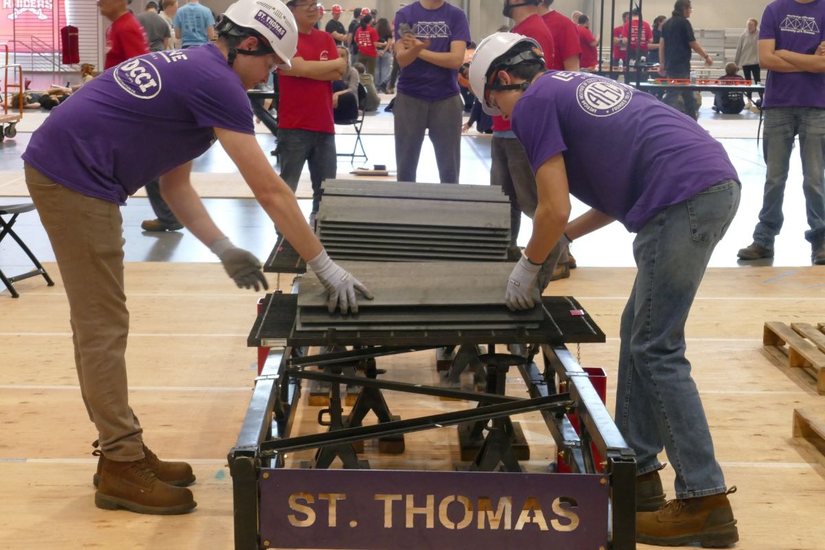 Civil engineering students work on steel bridge project.