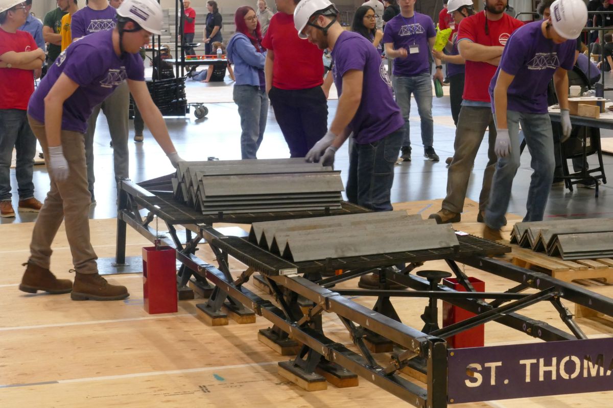 Civil engineering students work on steel bridge project.