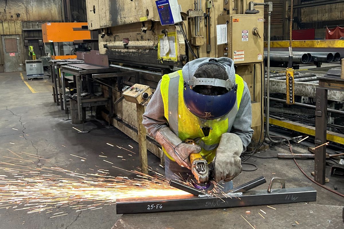 Civil engineering students work on steel bridge project.