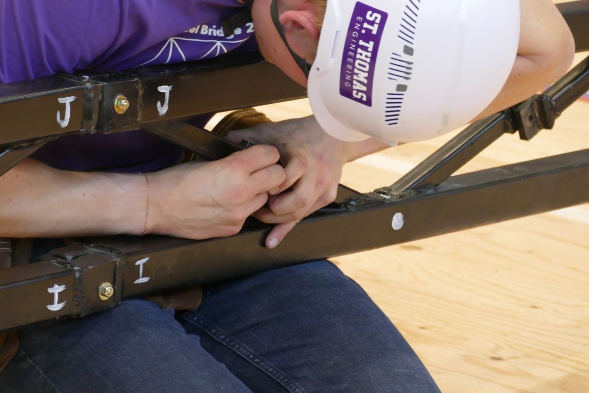 Civil engineering students work on steel bridge project.