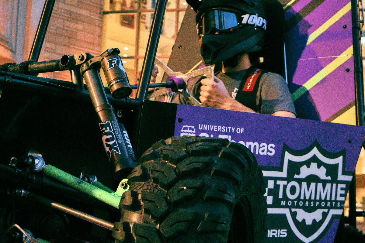 Tommie Motorsports club member interacts with vehicle.