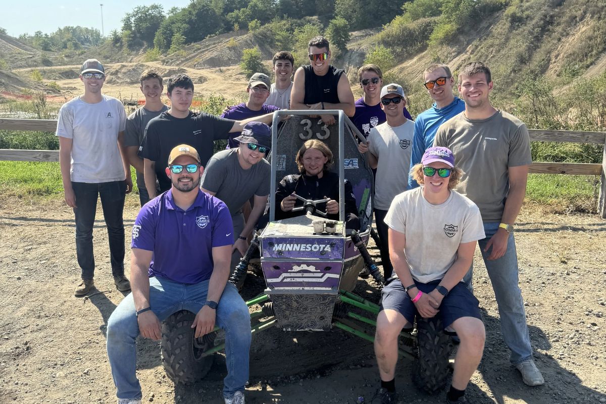 Tommie Motorsports club members interact with vehicle.