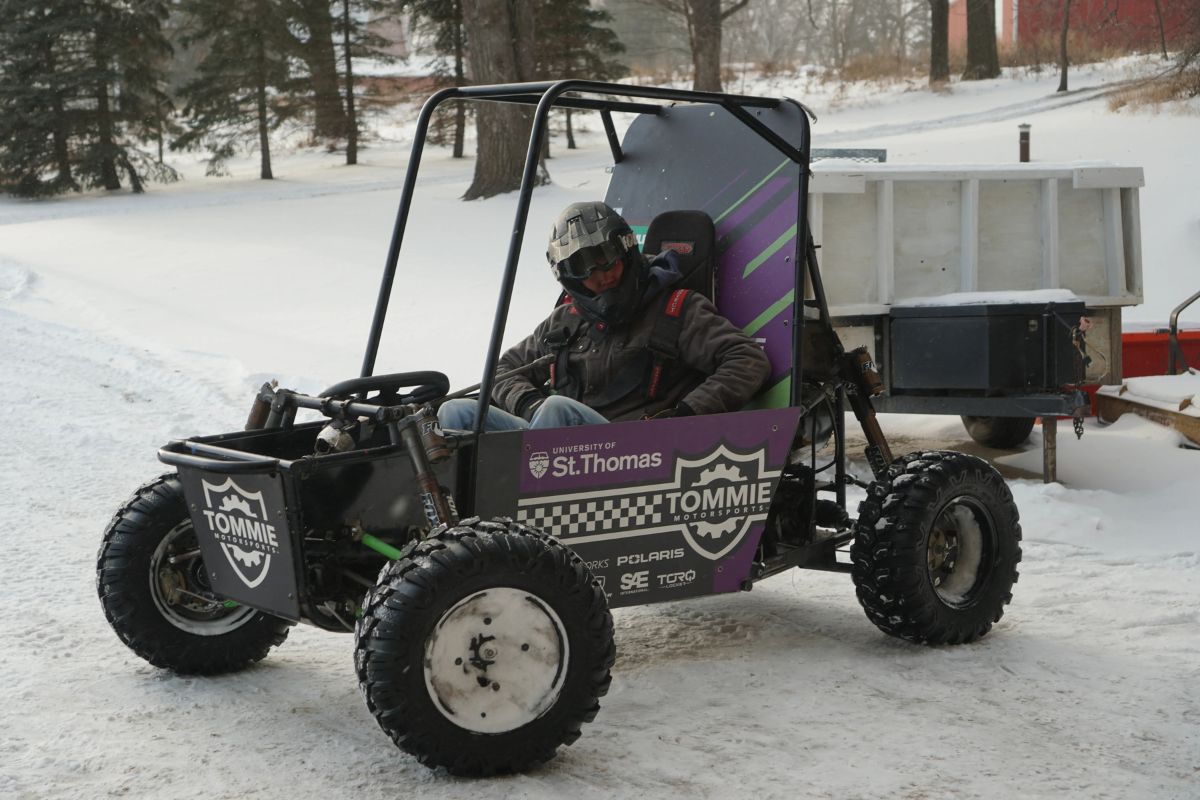 Tommie Motorsports club member interacts with vehicle.