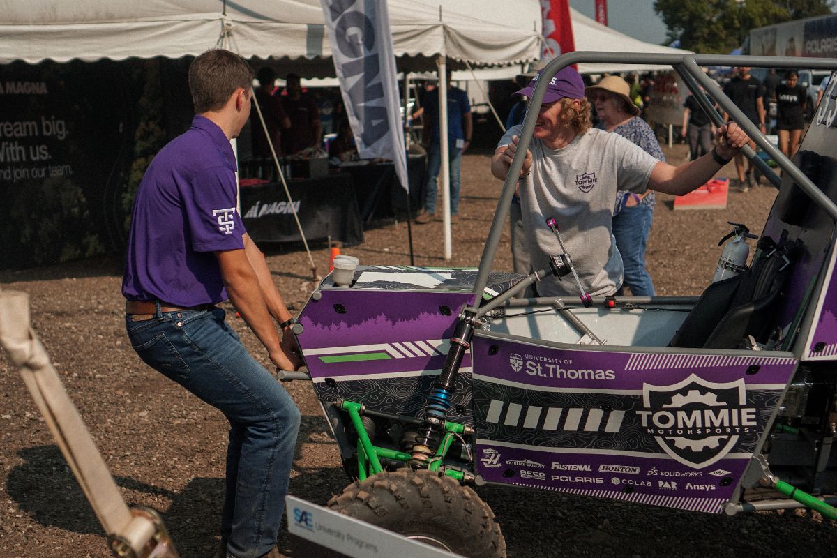 Tommie Motorsports club member interacts with vehicle.