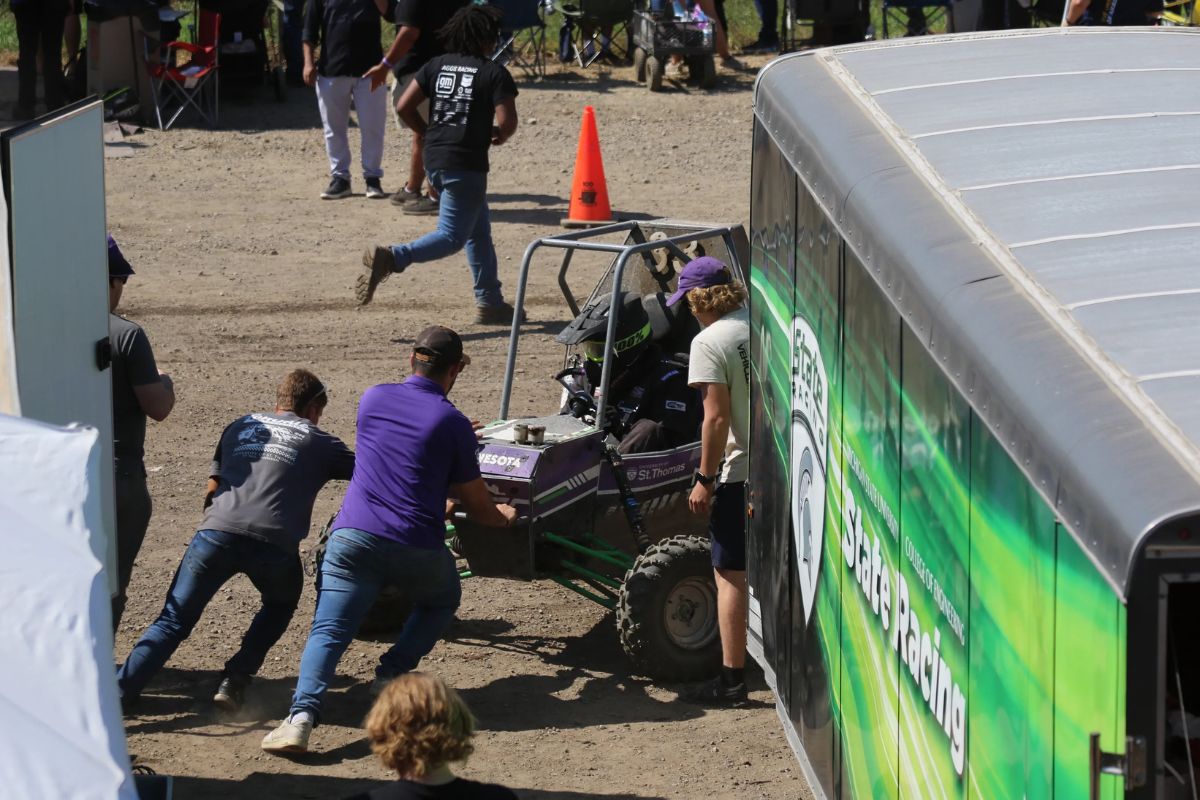 Tommie Motorsports club member interacts with vehicle.