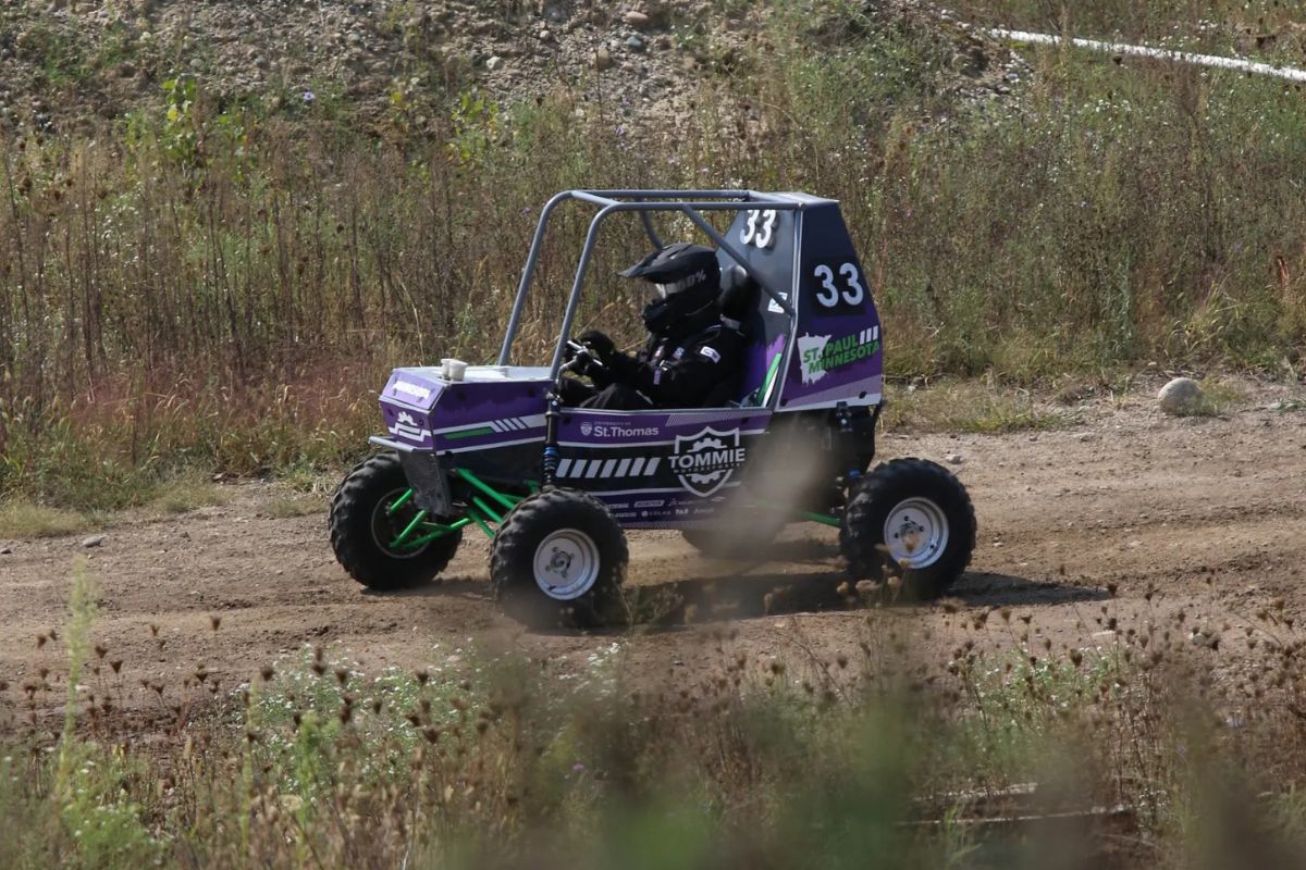 Tommie Motorsports club member interacts with vehicle.