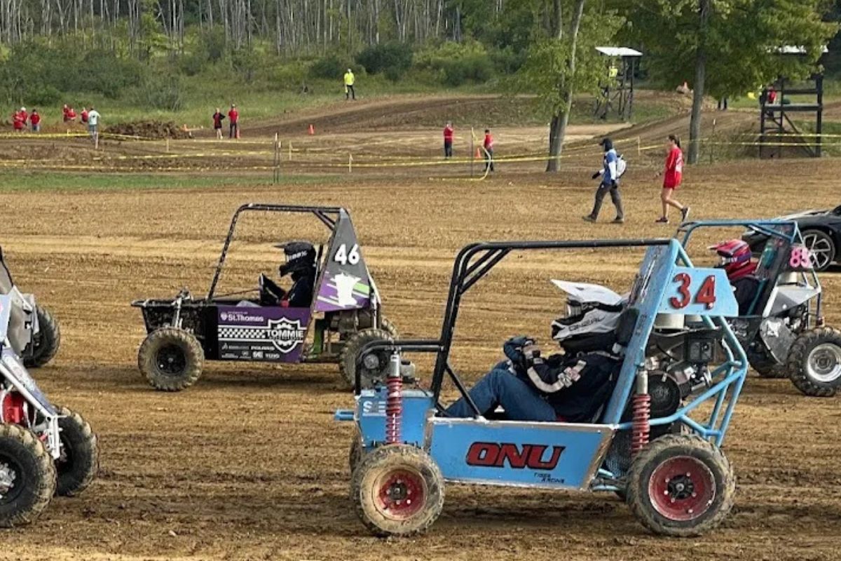 Tommie Motorsports club member interacts with vehicle.